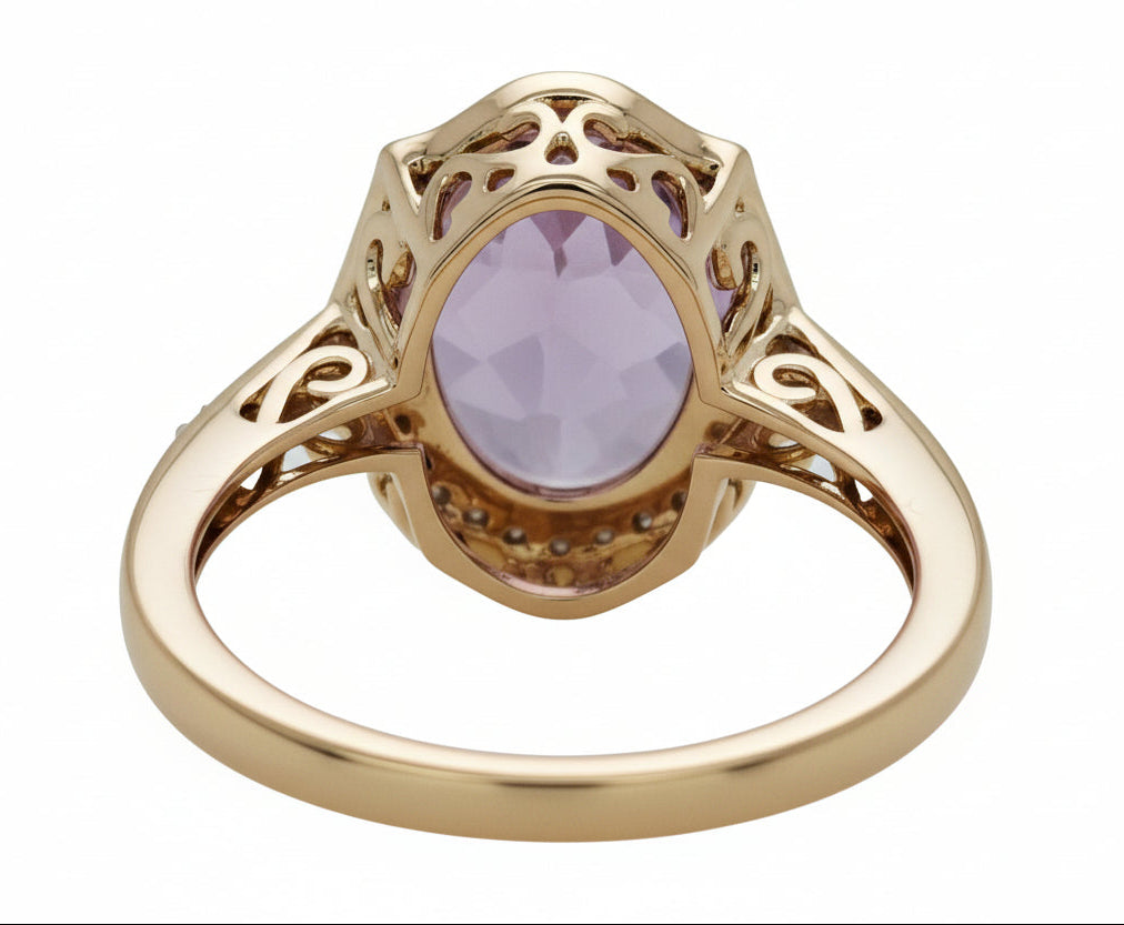 Gold ring with a purple gemstone on a white background