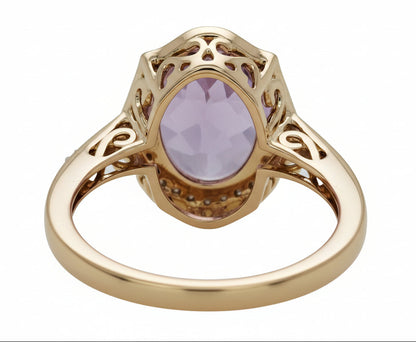 Gold ring with a purple gemstone on a white background