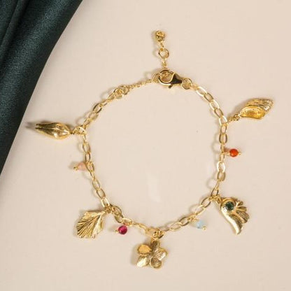 Flat lay of gold charm bracelet