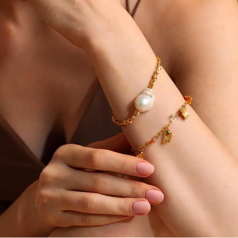 gold bracelets on model's wrist